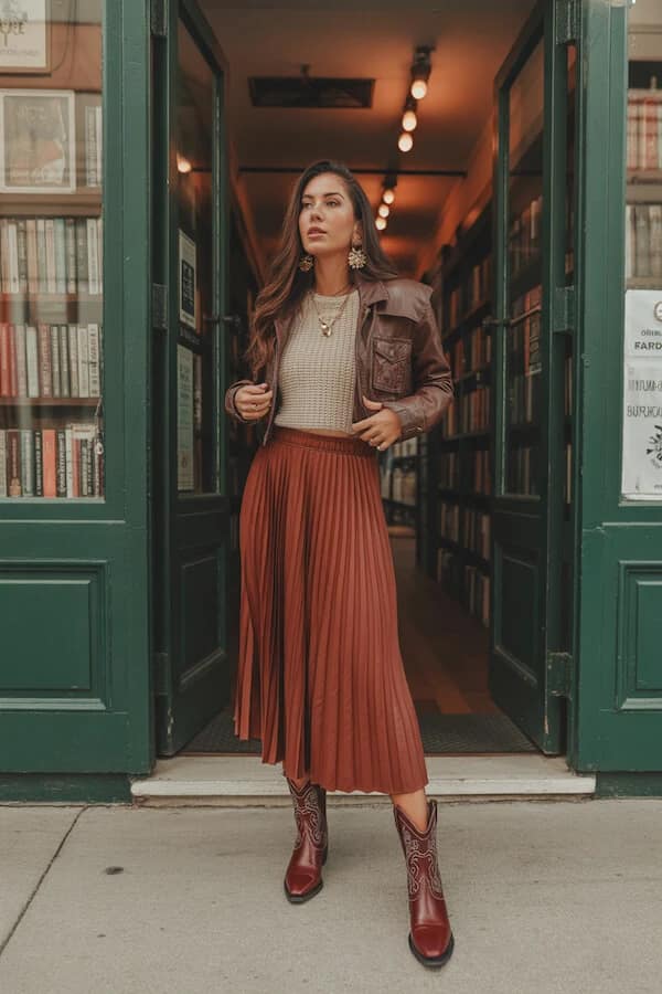 Rust Pleated Midi Skirt Outfit with Leather Jacket and Cowboy Boots