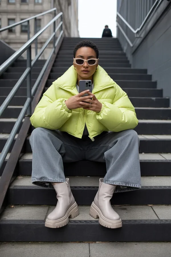 Neon Yellow Puffer Jacket with Wide-Leg Grey Jeans and Platform Boots