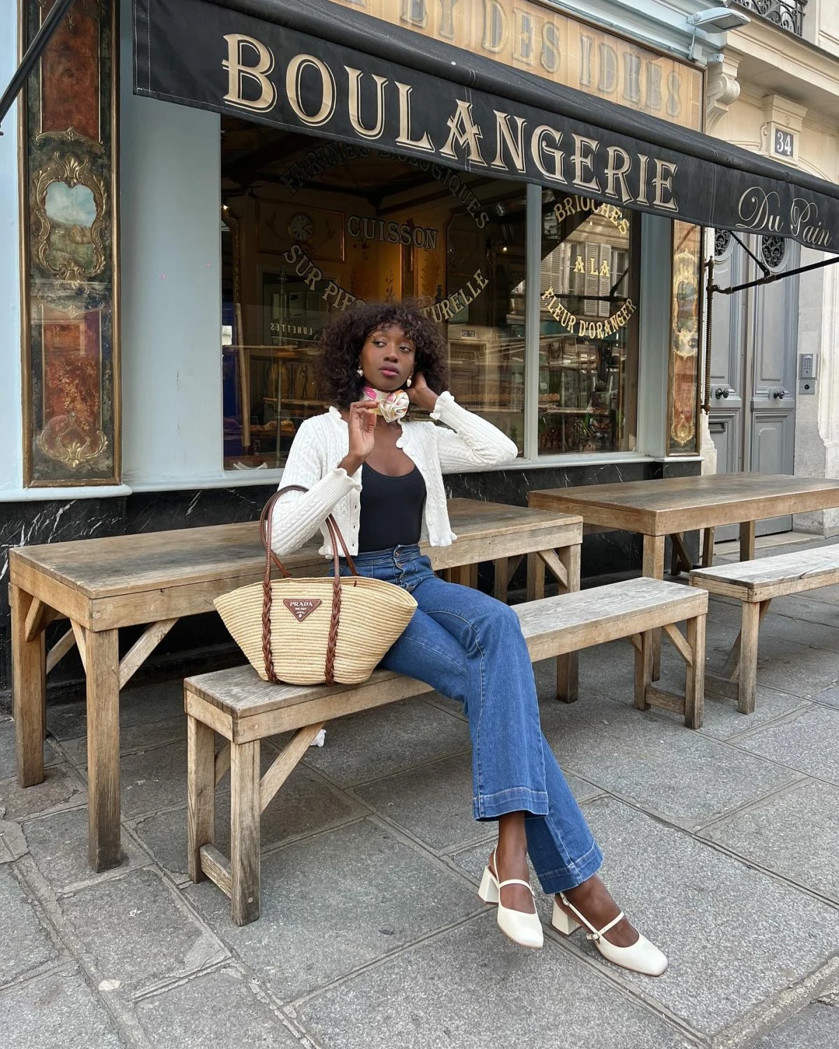 White Cropped Cardigan Flared Jeans Outfit with Straw Bag