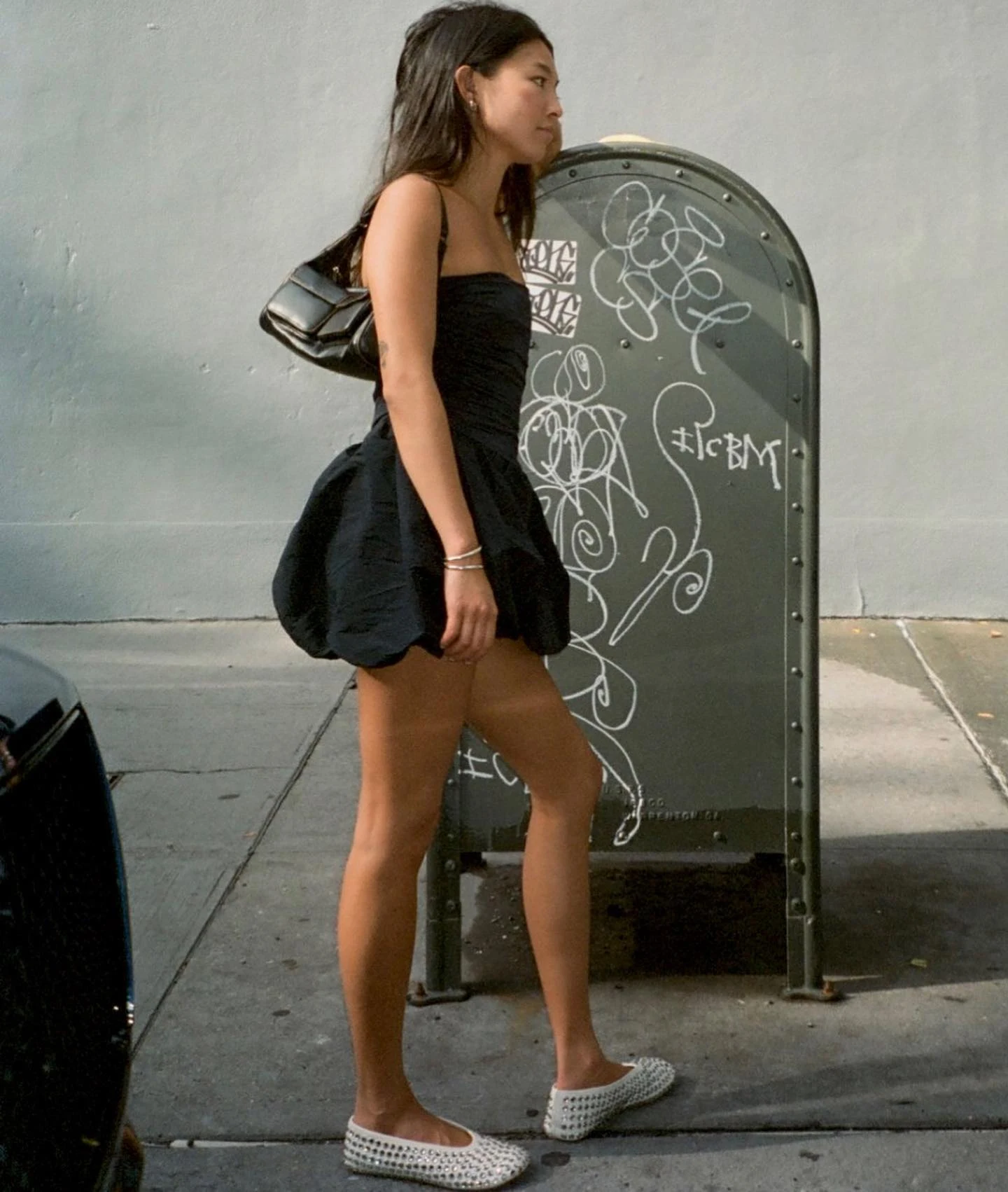 Black Strapless Bubble Mini Dress Outfit with Studded Flats