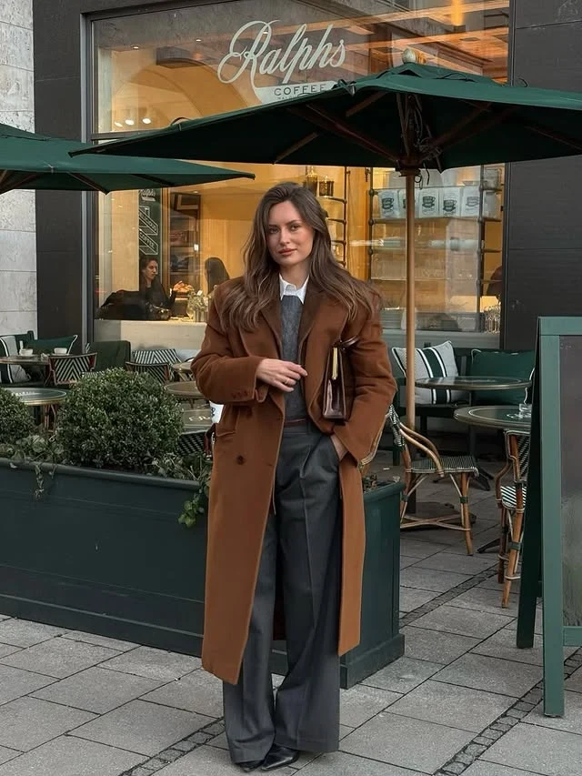 Camel Coat Outfit with Gray Knit Vest and Wide-Leg Trousers