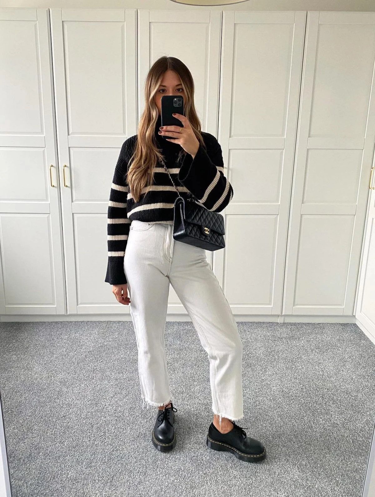 Black and Cream Striped Sweater White Jeans Outfit