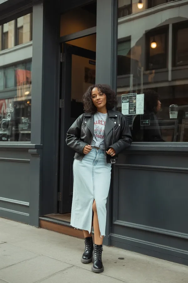 Black Leather Biker Jacket with Light Denim Midi Skirt and Combat Boots