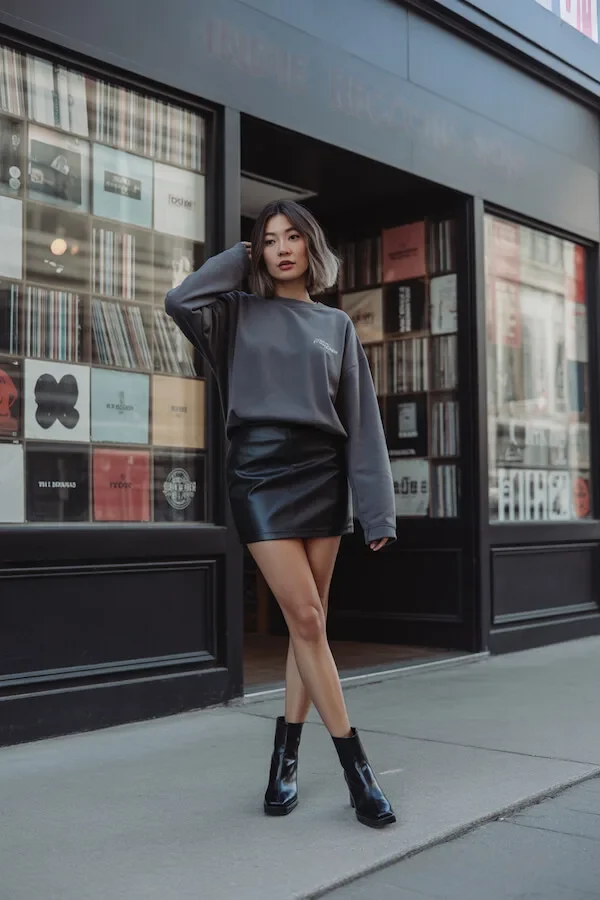 Charcoal Oversized Sweatshirt with Black Leather Mini Skirt and Ankle Boots